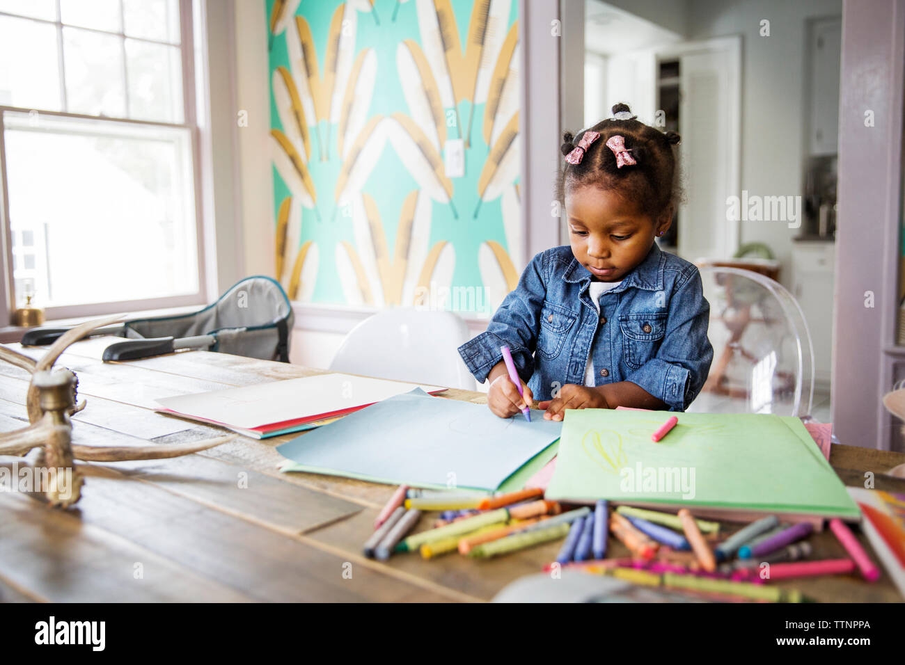 Cute Girl Coloring With Crayon In Book On Table At Home Stock Photo Alamy